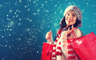 Happy woman shopping in the snow.