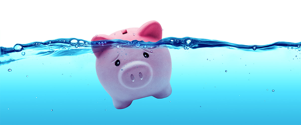 Stressed piggy bank floating in water.